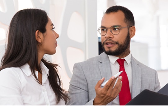 Woman talking to Man in a business meeting